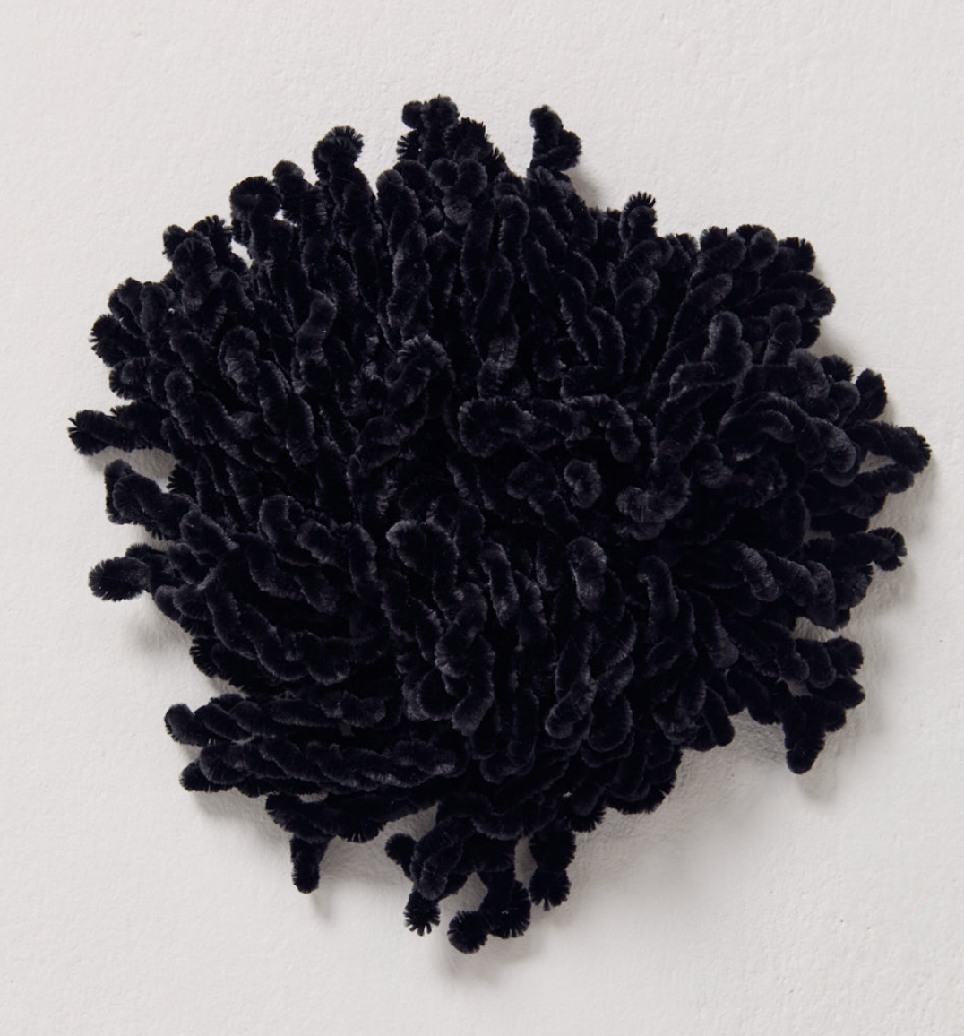 Black velvet hijab volumiser scrunchie worn under hijab for added volume.