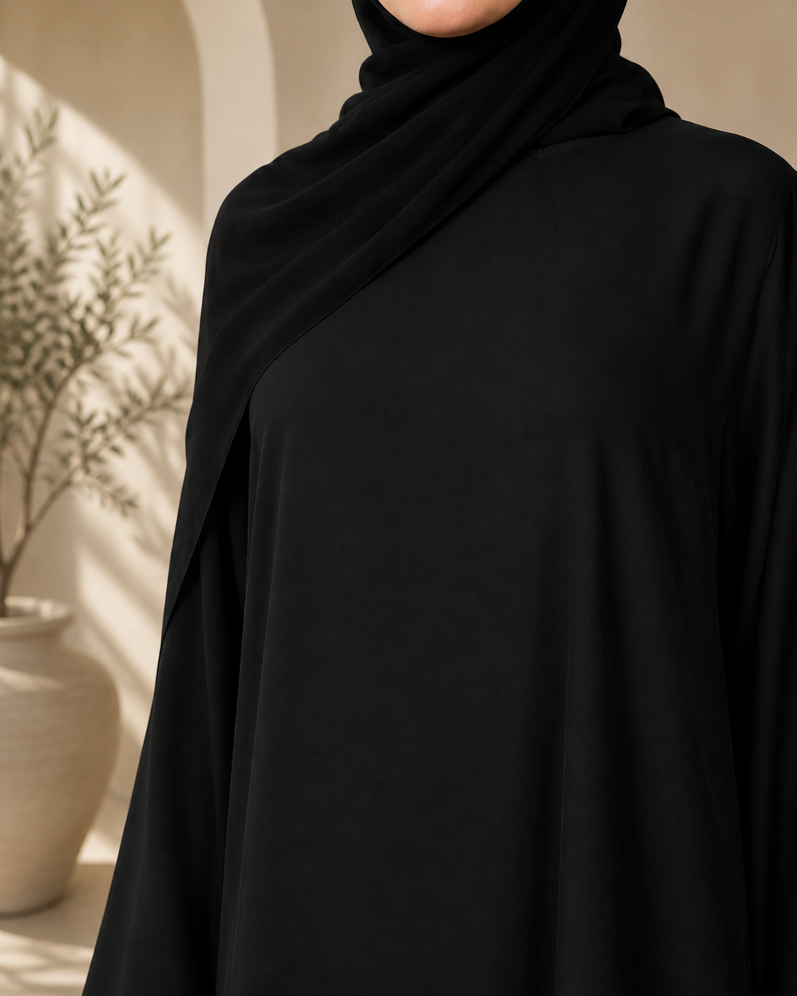 Close-up texture view of black nida abaya fabric with elegant drape and smooth finish