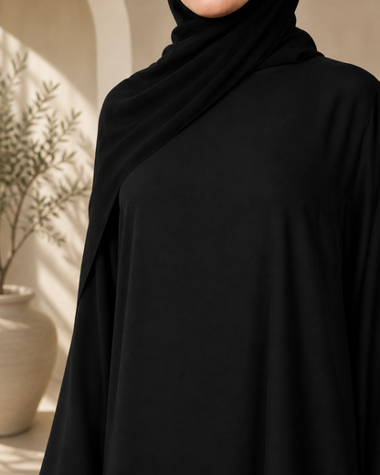 Close-up texture view of black nida abaya fabric with elegant drape and smooth finish