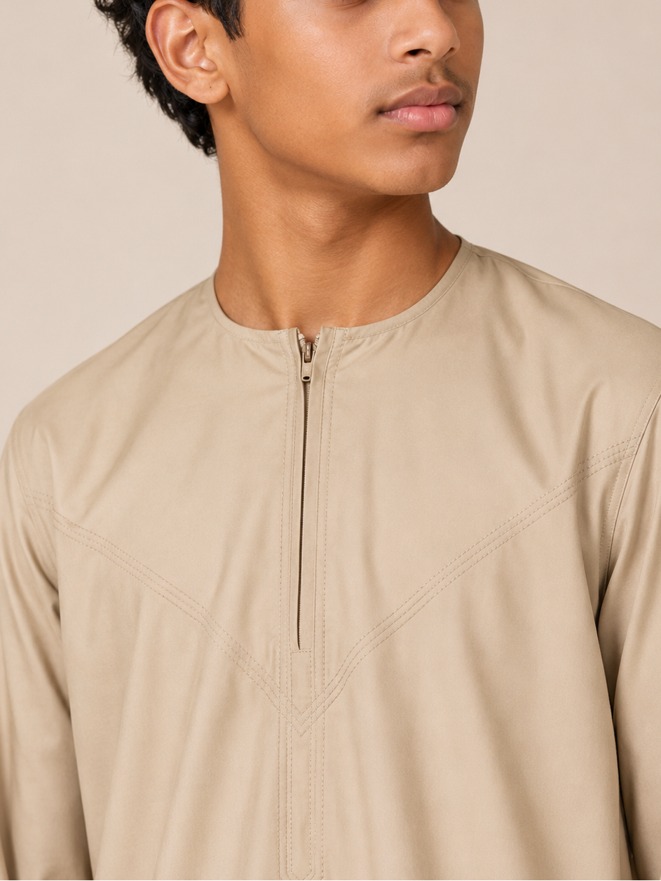 Close-up of the Omani thobe neckline featuring a front zip closure and premium stitching in sand beige fabric.