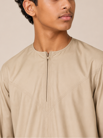 Close-up of the Omani thobe neckline featuring a front zip closure and premium stitching in sand beige fabric.
