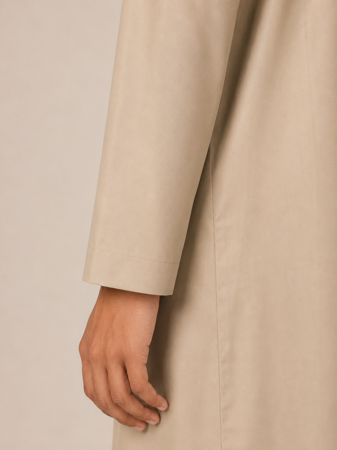 Close-up sleeve detail of a boys premium Omani thobe in sand beige showcasing the smooth fabric and clean cuff finish.