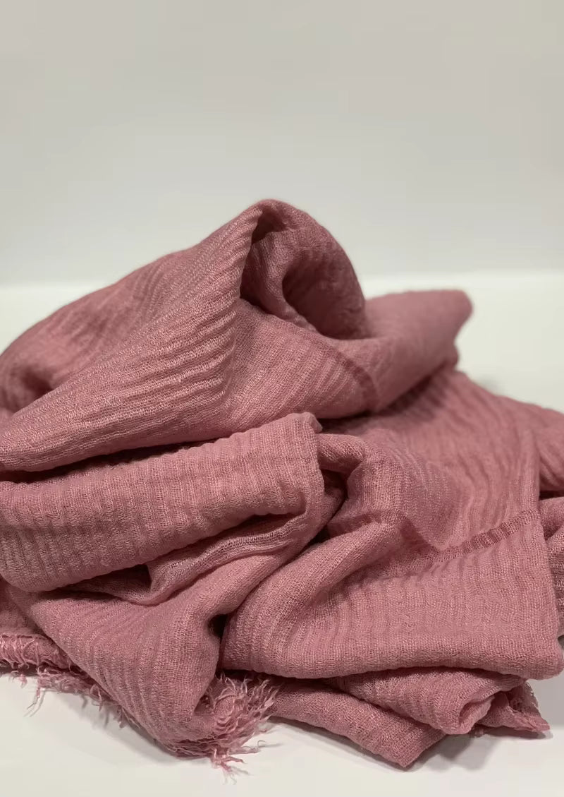 Crinkle cotton hijab with textured finish and frayed edges.