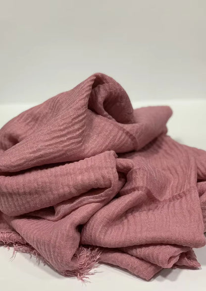 Crinkle cotton hijab with textured finish and frayed edges.