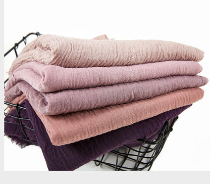 Lightweight crinkle cotton scarf featuring a voluminous, textured finish.