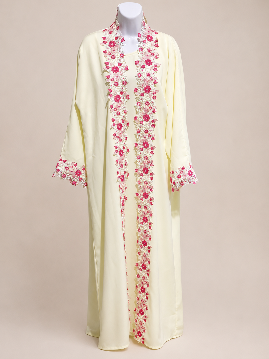 ZAHRA Butter Yellow Floral Lace Open Abaya displayed on a mannequin, showcasing the elegant floral lace trim and flowing Nida fabric
